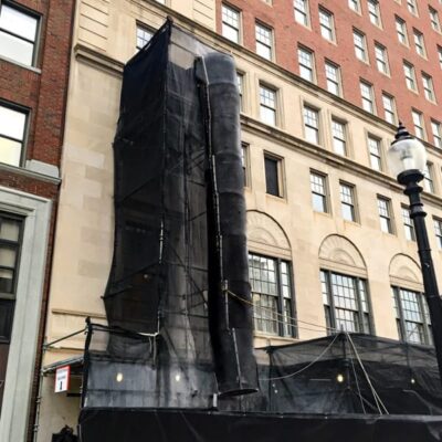 Black Superchute installed on scaffolding.